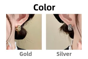 Detail of luxury C-shaped leopard print earrings in gold and silver finish on model