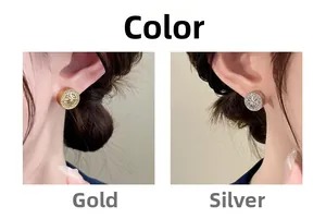 Detail of round compass stud earrings with pavé zircons in gold and silver finish