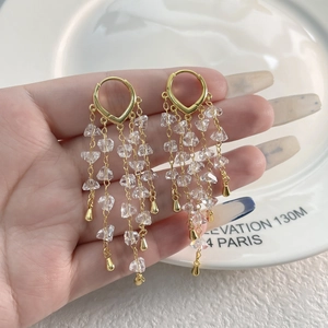 18K gold-plated tassel earrings with heart buckle and sparkling crystals on white porcelain