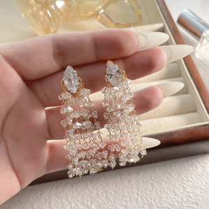 Elegant gold drop earrings featuring diamond-shaped crystals and long hanging tassels
