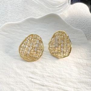 Close-up of 18k gold plated hollow mesh oval earrings with sparkling cubic zirconia stones
