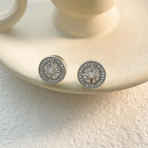 Macro shot of silver circular starburst stud earrings with micro-pave cubic zirconia