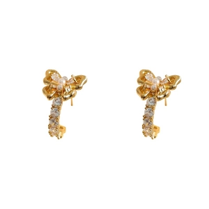 Elegant gold double bow earrings with pearls and crystal pavé on white background