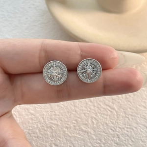 Close-up of sparkling starburst stud earrings with brilliant zircon pavé setting