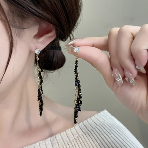 Elegant gold chain tassel earrings with black beads and sparkling cubic zirconia stud