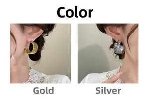 Detail of C-shaped woven texture earrings in gold and silver finishes