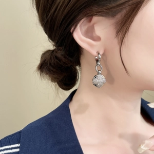 Detail of elegant silver long drop earrings with micro-pave zircon spherical pendants