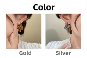 Detail view of geometric layered flower earrings in gold and silver metallic finishes