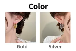 Detail of round braided knot earrings in gold and silver finish shown on model