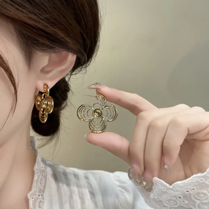 Fashionable gold layered hollow flower earrings with crystals for a modern minimalist look