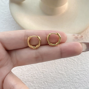 Minimalist geometric circle hoop earrings with irregular facets in 18K gold plated copper