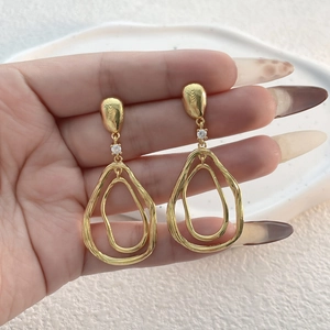 Boucles d'oreilles dorées avec double anneau goutte et zircon au design minimaliste