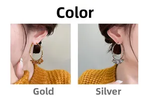 Fashionable large hoop earrings with camellia flower details in gold and silver finish