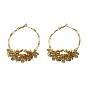 Golden camellia hoop earrings with twisted metal texture and sparkling crystal accents