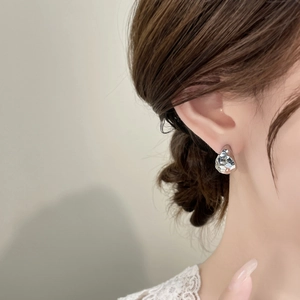 Minimalist hammered C-shape stud earring with irregular silver finish on female model