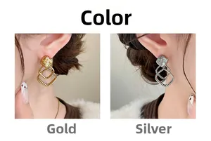 Macro detail of geometric square earrings in gold and silver finish options