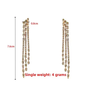 Detail view of gold tassel earrings with zircon stones showing 7.6cm length and 4g weight