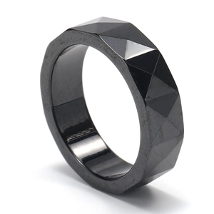 Minimalist black geometric rhombus ceramic ring featuring a polished faceted design