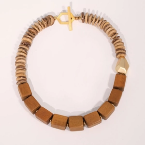 Handmade wooden beaded necklace with brown discs and gold toggle clasp on gray background