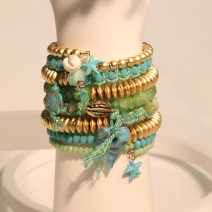 Bohemian multi-layer wrap bracelet with sea turtle and starfish charms on a wrist