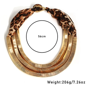 Detail of layered gold wavy metal tubes and leopard print fabric multi-row necklace