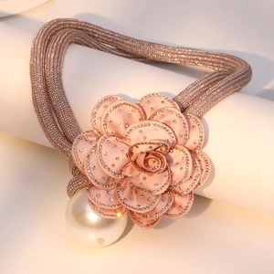 Close-up of pink camellia necklace with rhinestone edges and a large pearl pendant