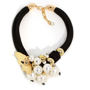 Exaggerated choker with multiple black cords, white pearls, and a golden bee charm