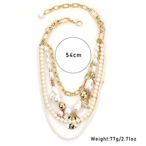 Detail view of multi-layered faux pearl necklace with gold pendants and 54cm length