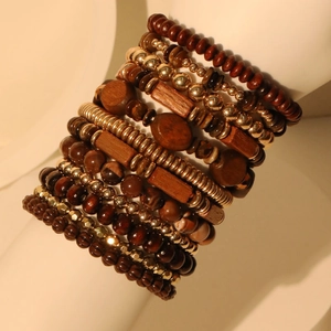 Bohemian multi-layer handmade wood bead bracelet set with metallic accents on a model