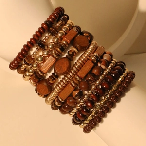 Bohemian multi-layer wooden bead bracelet set with gold metallic accents on display