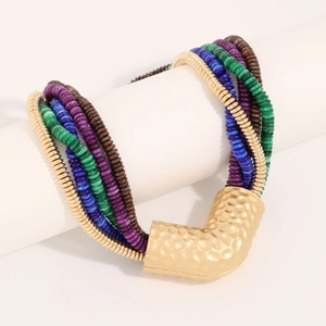 Close-up of bohemian multi-layer beaded necklace with hammered gold V-pendant detail
