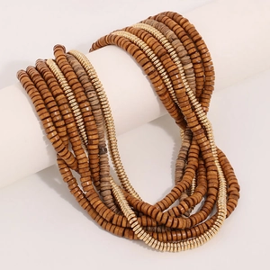 Handmade multi-layer bohemian wooden bead necklace with gold accents on a white stand