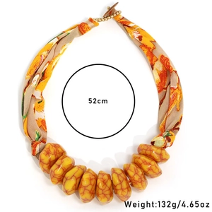 Detail of bohemian floral fabric necklace with yellow marble resin beads, 52cm long