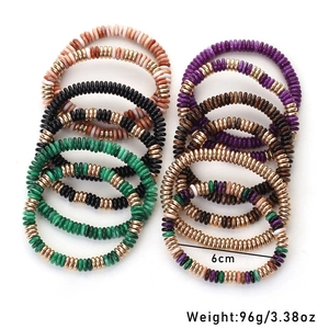 Macro detail of 12-piece bohemian acrylic and clay beaded stretch bracelet set