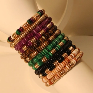 Bohemian multilayered acrylic bead bracelet set with golden spacers on a display stand