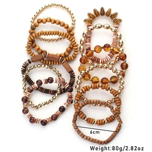 Close-up of bohemian layered wooden bead bracelet set with gold metal accents
