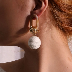 Handcrafted round earrings with amber resin links and white cotton thread wrapped spheres