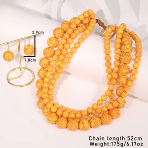 Detail shot of orange marble acrylic beaded necklace and earrings with dimensions