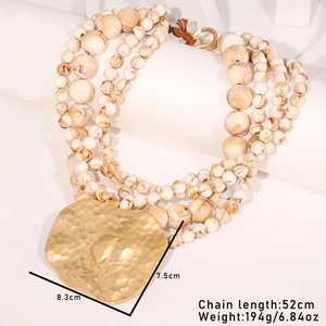 Macro view of multi-layer beaded necklace with hammered gold pendant and dimensions