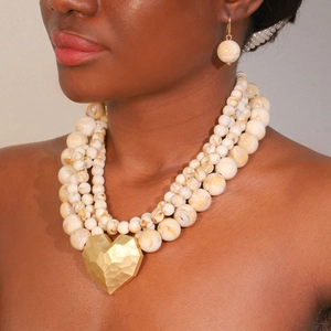Multi-layer beaded necklace and earring set with a hammered gold heart pendant