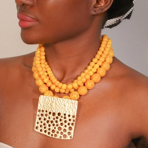 Multilayer yellow marble bead necklace featuring a hammered gold hollow square pendant