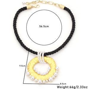 Statement rope necklace with large gold hammered pendant and inlaid white pearls