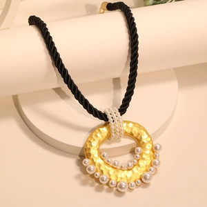Statement twisted rope necklace with gold hammered circular pendant and pearl accents