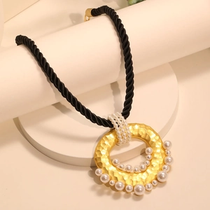 Twisted rope necklace featuring a hammered gold ring pendant with pearl accents