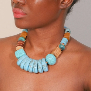 Handmade bohemian necklace with blue turquoise and geometric wooden beads on model