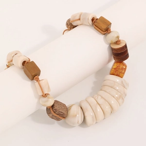 Handmade wooden and turquoise beaded necklace with geometric stones on a display stand