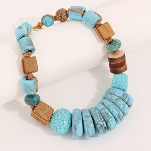 Detailed view of handmade geometric wooden and turquoise beaded necklace on white stand
