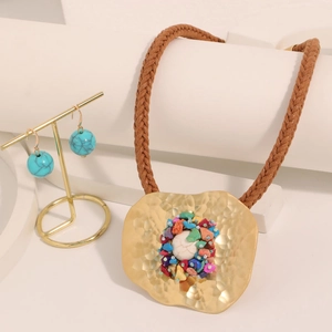 Bohemian colorful natural stone necklace with hammered gold pendant on white stand