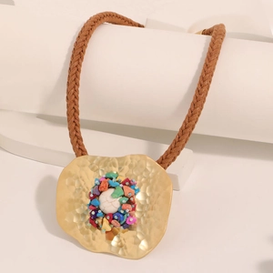 Bohemian style necklace with a hammered gold pendant and colorful natural stones