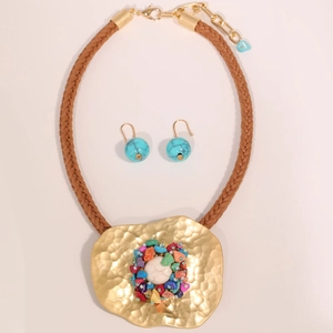 Detail of colorful stone necklace set with irregular gold hammer textured metal plate